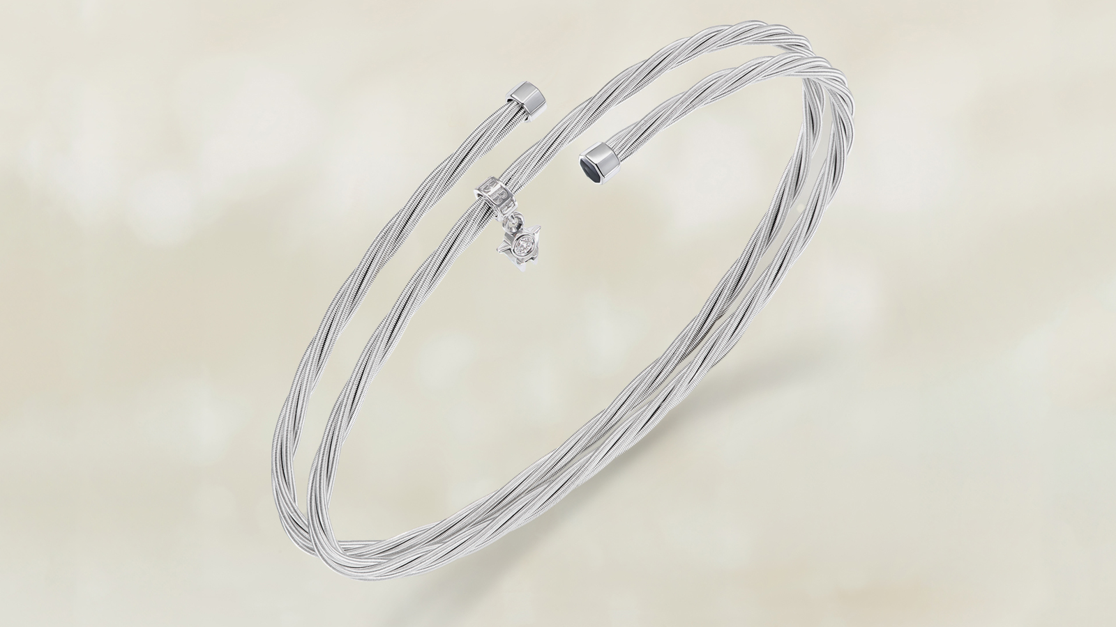 Das Armband UMARME MICH Power of gold aus seidenweichem federndem 18 Karat Weißgold. Auf grauem Mood Hintergrund.