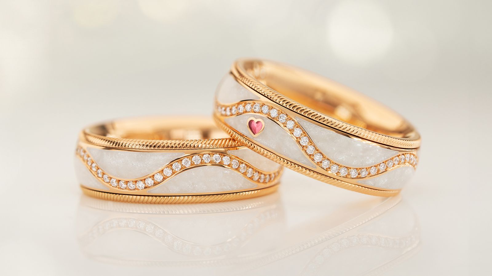 Der drehbare Ring MEIN GLÜCK brillant in 18-karätigem Gold und perlmutt-weißer Kaltemaille.